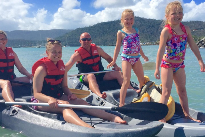 a group of people riding on the back of a boat